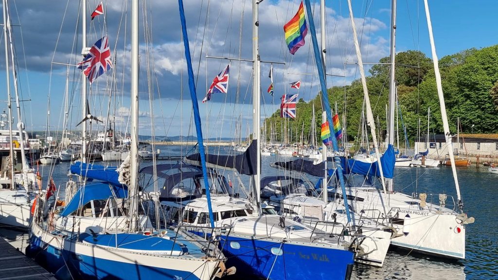sailing boats and rainbow flags